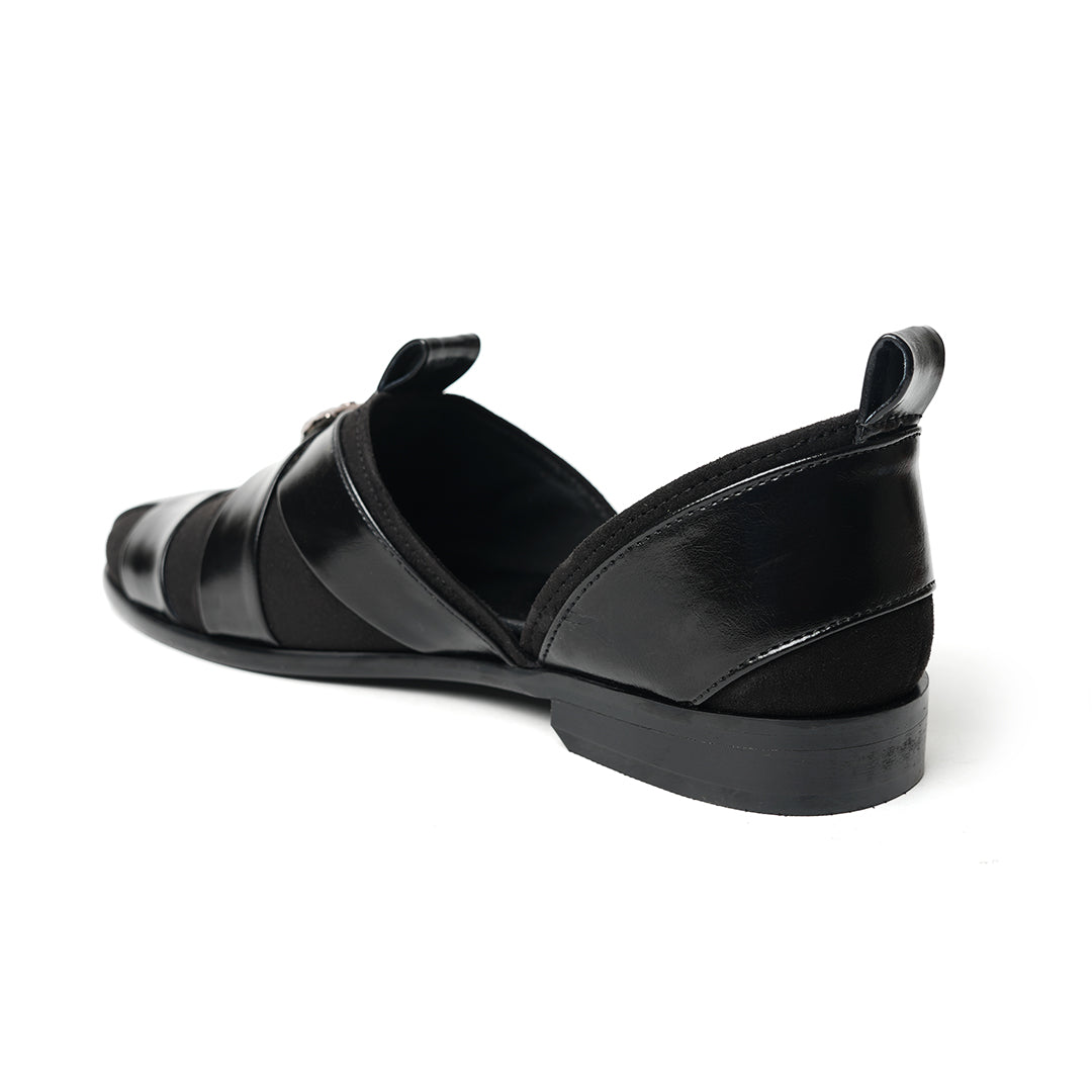 A sophisticated Monkstory Criss Cross Slip-On Sandal - Black leather shoe with straps.