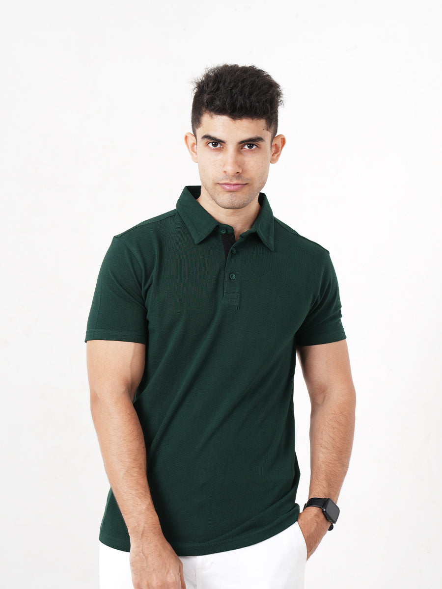 A man wearing a Monkstory Bamboo Cotton Polo Tee - Pine Green, a versatile option from Monkstory.