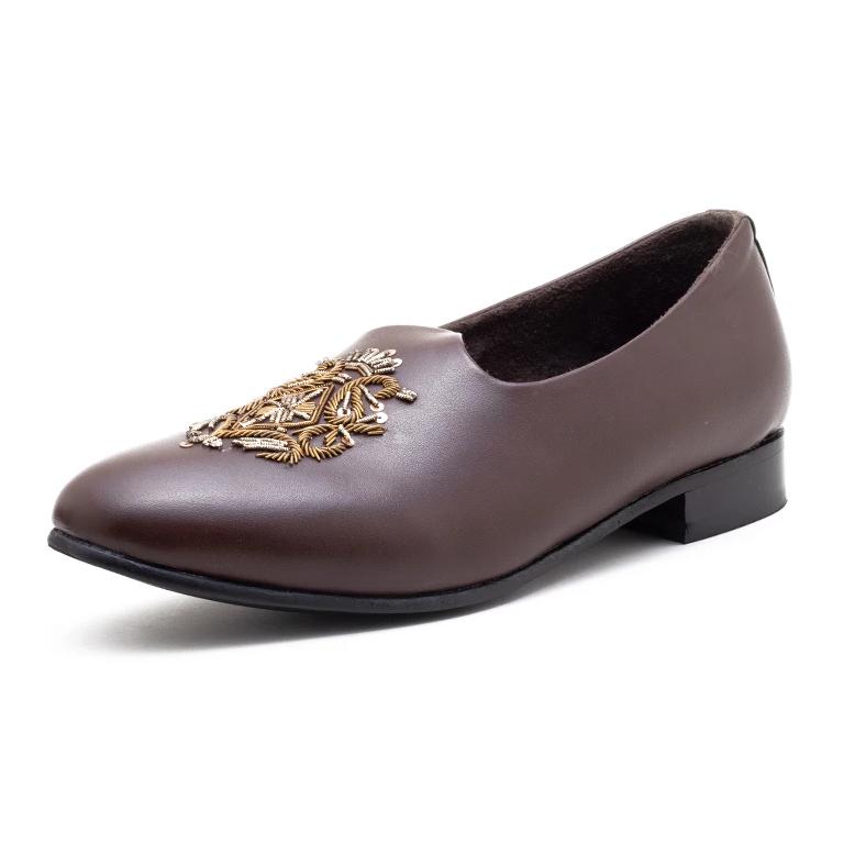 A pair of Monkstory Magenta Mojri shoes with brown embroidered designs.