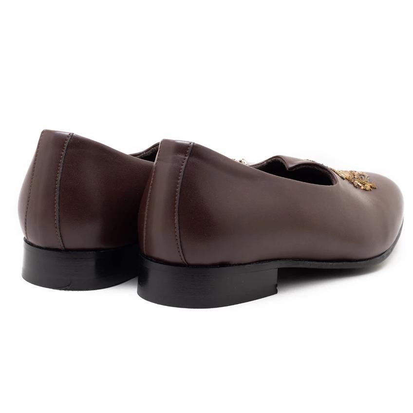 A pair of Monkstory Magenta Mojri shoes with brown embroidered designs.