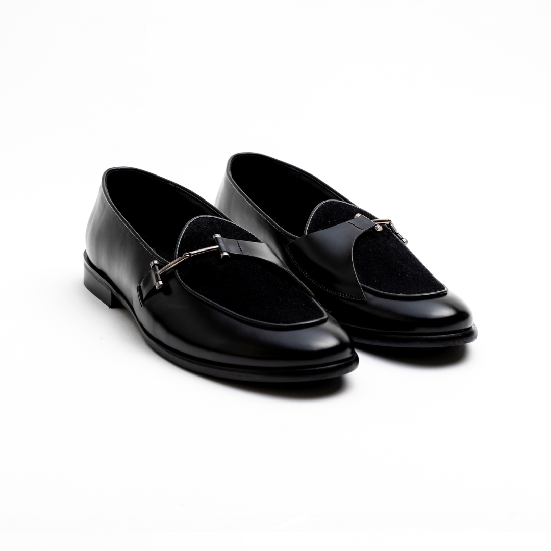 An Eclecta Side Buckle Slip On - Black/Black made of vegan leather.