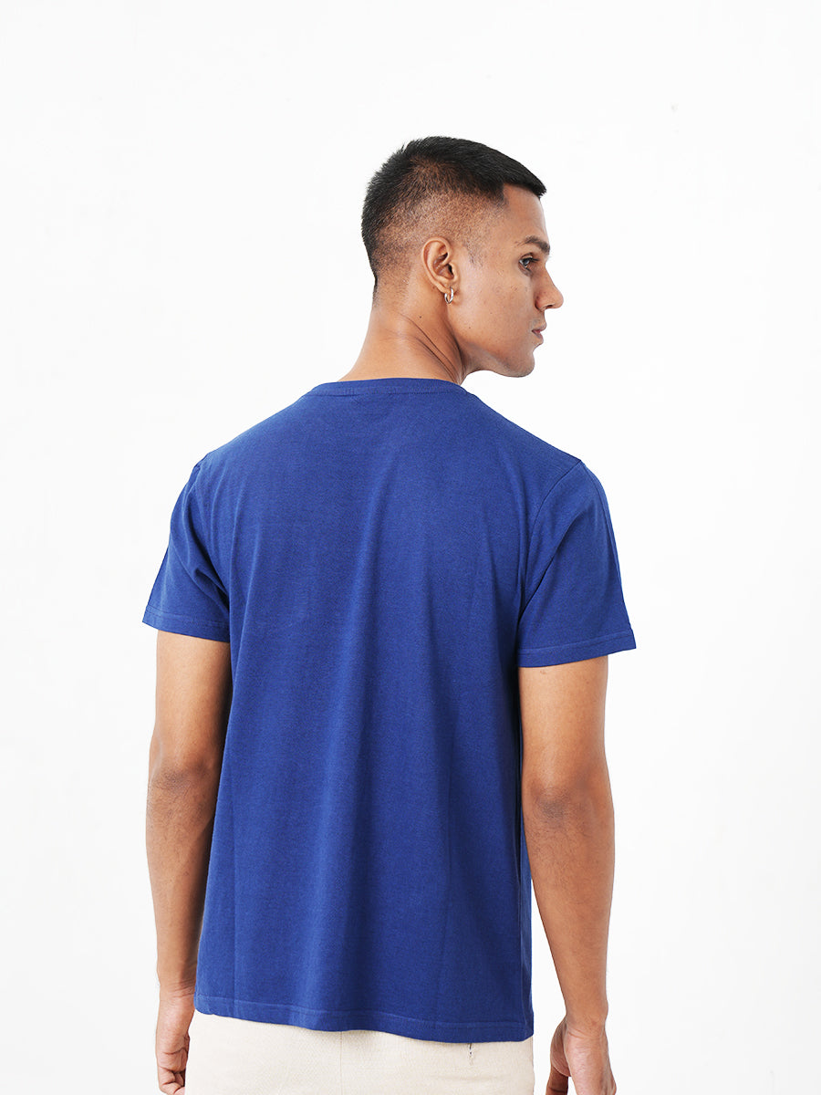 The Monkstory Bamboo Cotton Crew Tee, made of bamboo and cotton, features a man wearing a Midnight Blue t-shirt with a pocket.