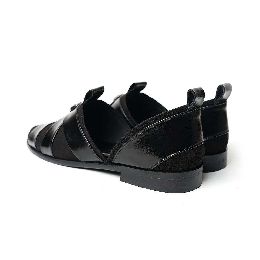 A sophisticated Monkstory Criss Cross Slip-On Sandal - Black leather shoe with straps.