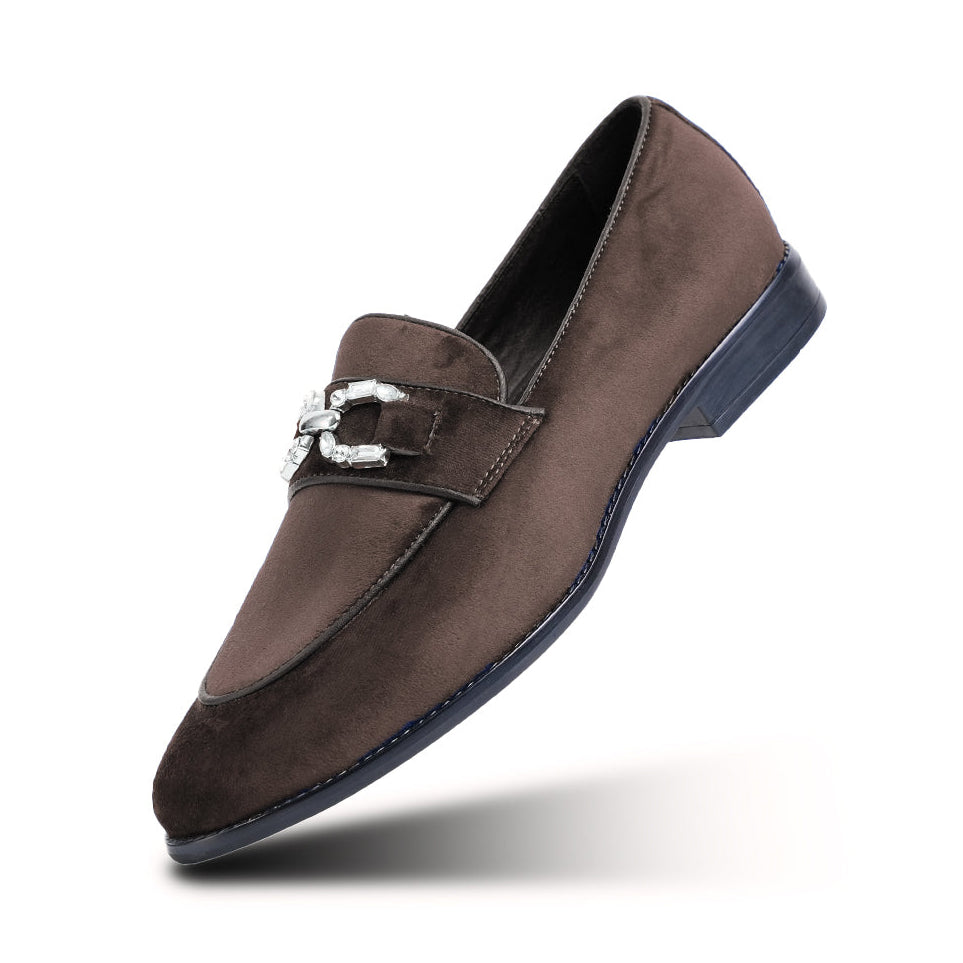 Brown suede loafer with a silver buckle on a white background