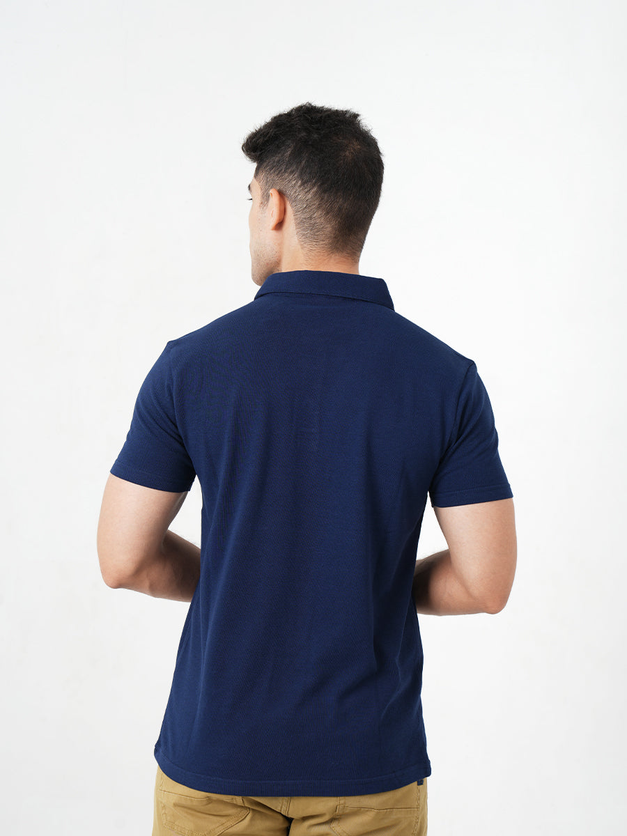 A man in a comfortable Monkstory Bamboo Cotton Polo Tee - Navy Blue posing for a photo.