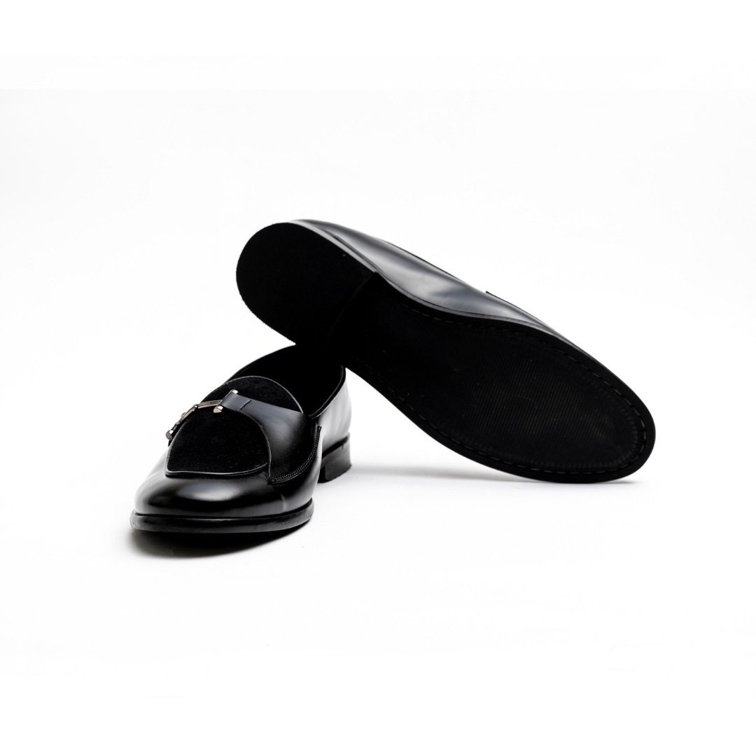An Eclecta Side Buckle Slip On - Black/Black made of vegan leather.