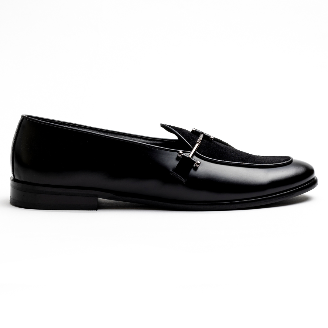 An Eclecta Side Buckle Slip On - Black/Black made of vegan leather.