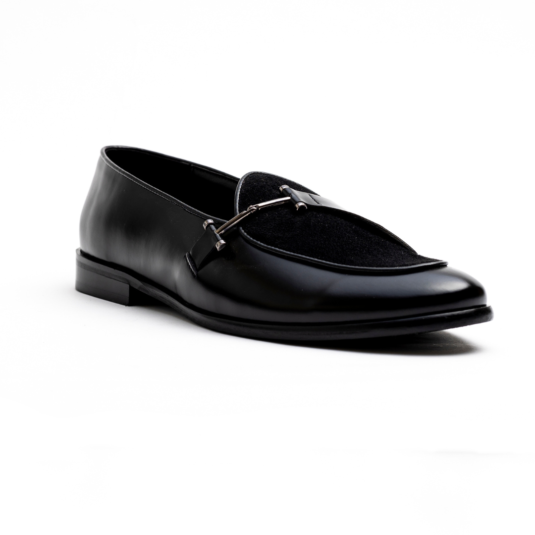 An Eclecta Side Buckle Slip On - Black/Black made of vegan leather.
